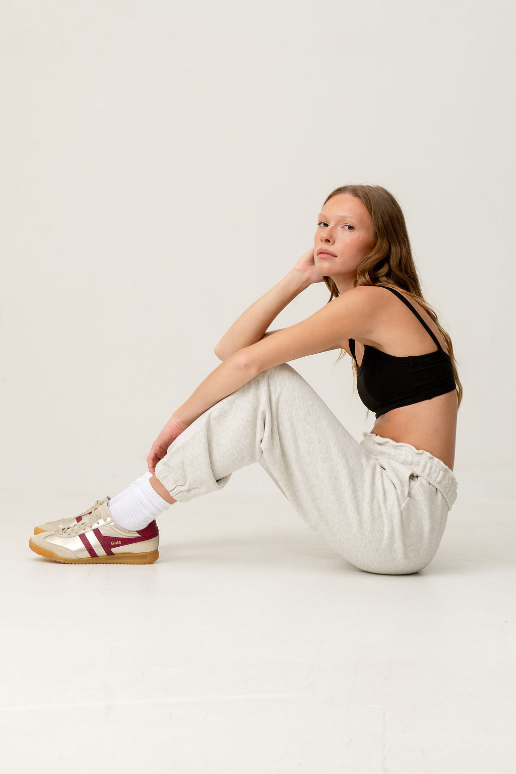 Women's grey loungewear joggers for everyday comfort, styled in a minimalist studio setting.